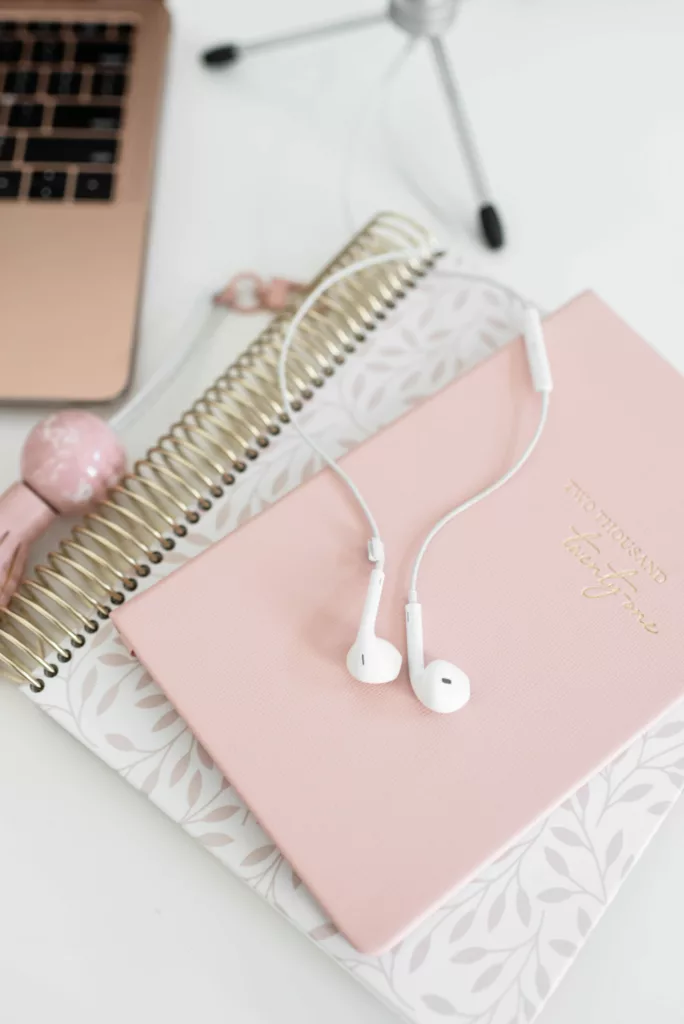 Pink planner with apple headphones